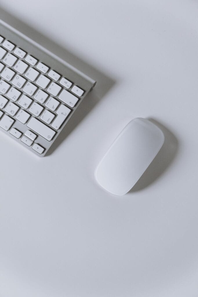 Apple Magic Mouse on White Table